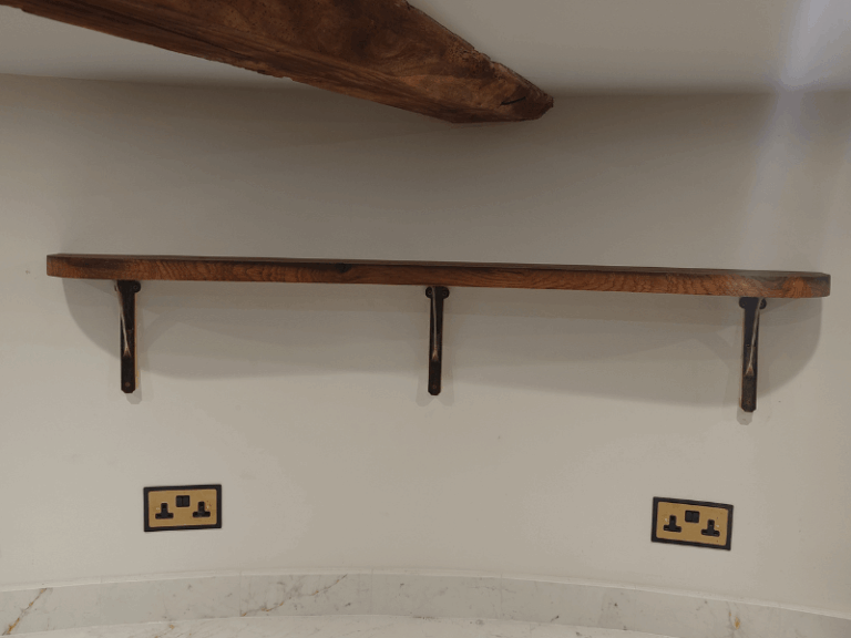 Handmade reclaimed oak shelf installed in historic windmill
