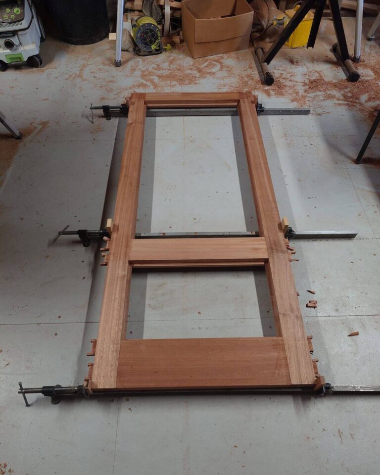 Joiner crafting bespoke timber doors in workshop