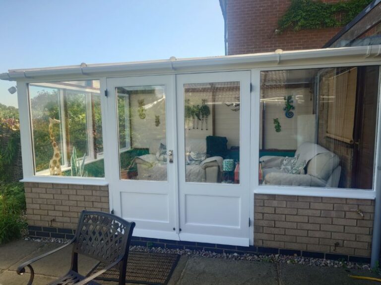 Conservatory with refurbished timber windows and French doors